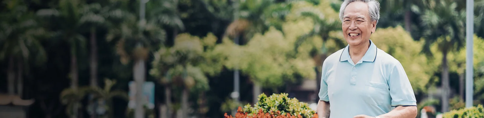 elderly walks through public park and smiles