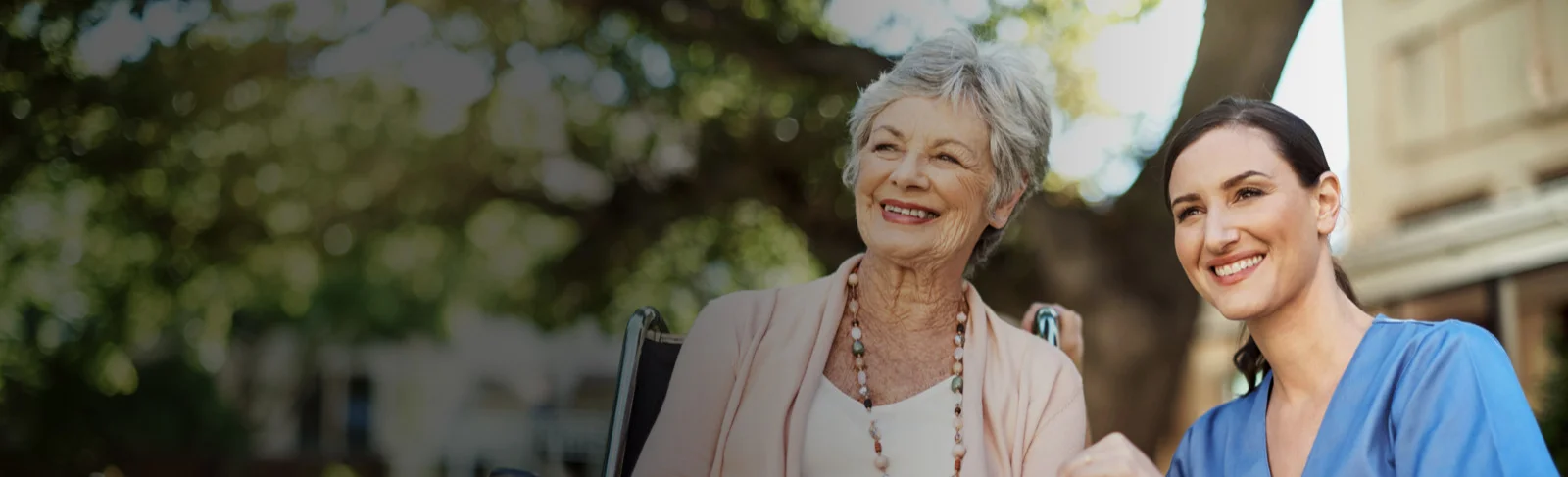 elderly woman and home health aide smiling